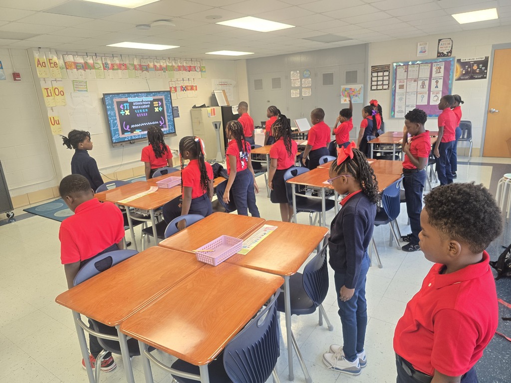 Students standing in class. 