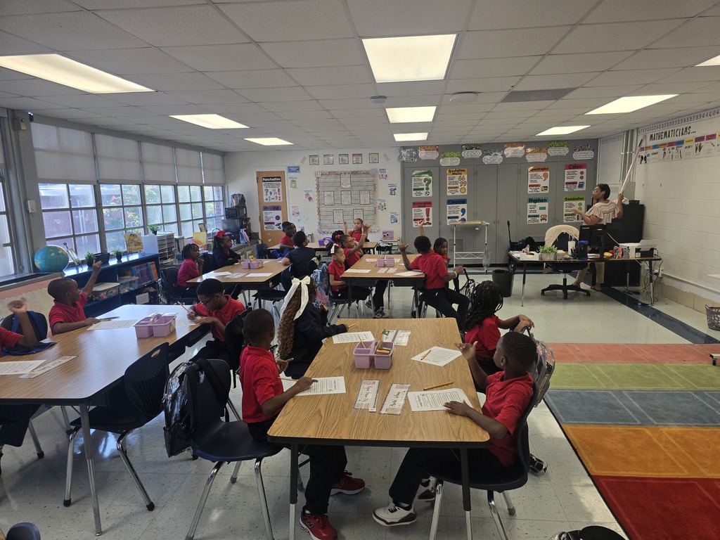 Students learning in class with the teacher guiding instruction. 