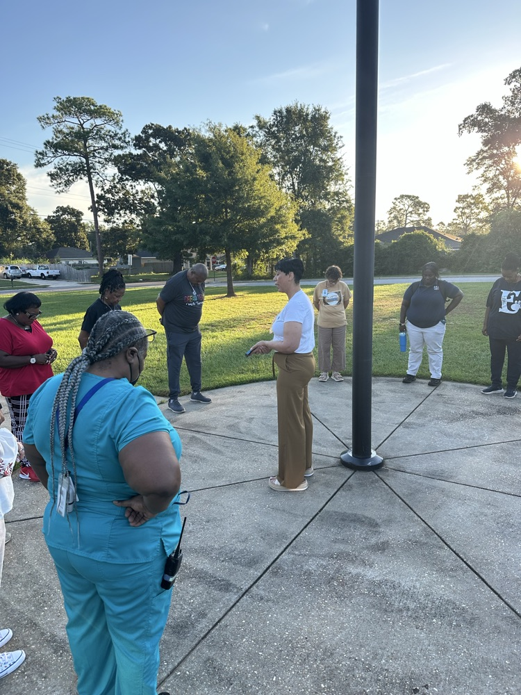 Mrs Kidd giving a word of encouragement to staff by the flagpole 