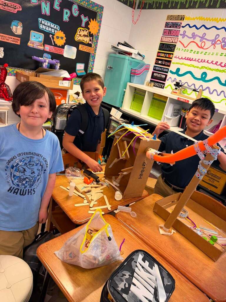 Three students and a Rube Goldberg machine