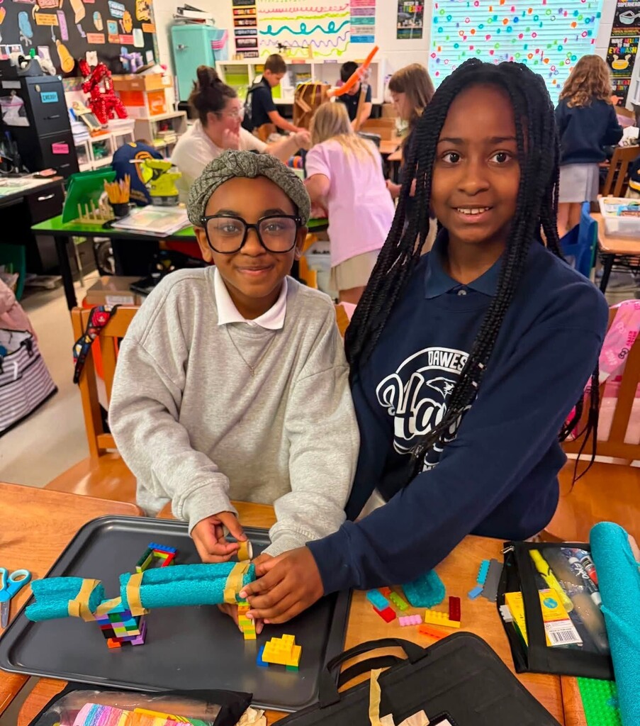 Two students and a marble ramp