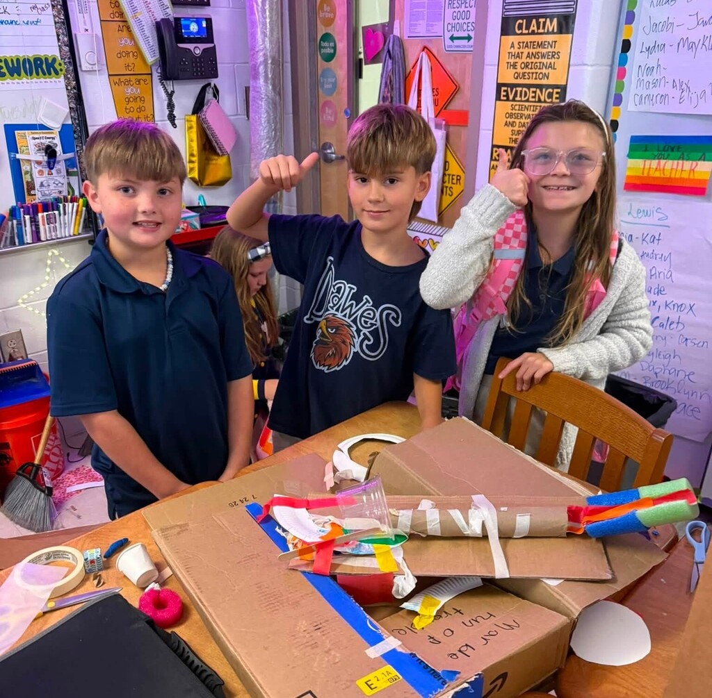 Three students and a marble ramp