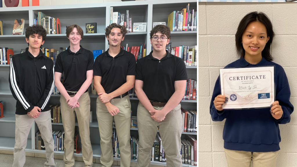 Four boys in black shirts and one girl holding a certificate