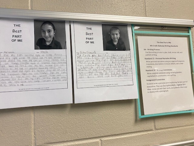 A classroom display with two black-and-white photos of students. Each photo has a written piece titled "The Best Part of Me."