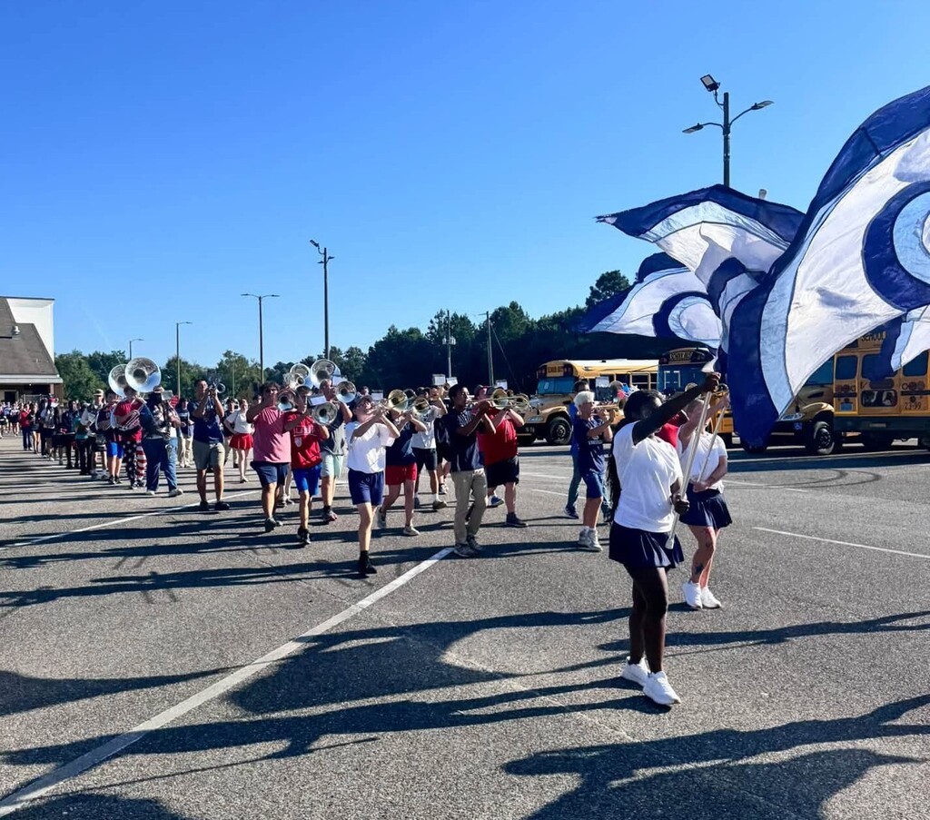 A marching band in a parking lot