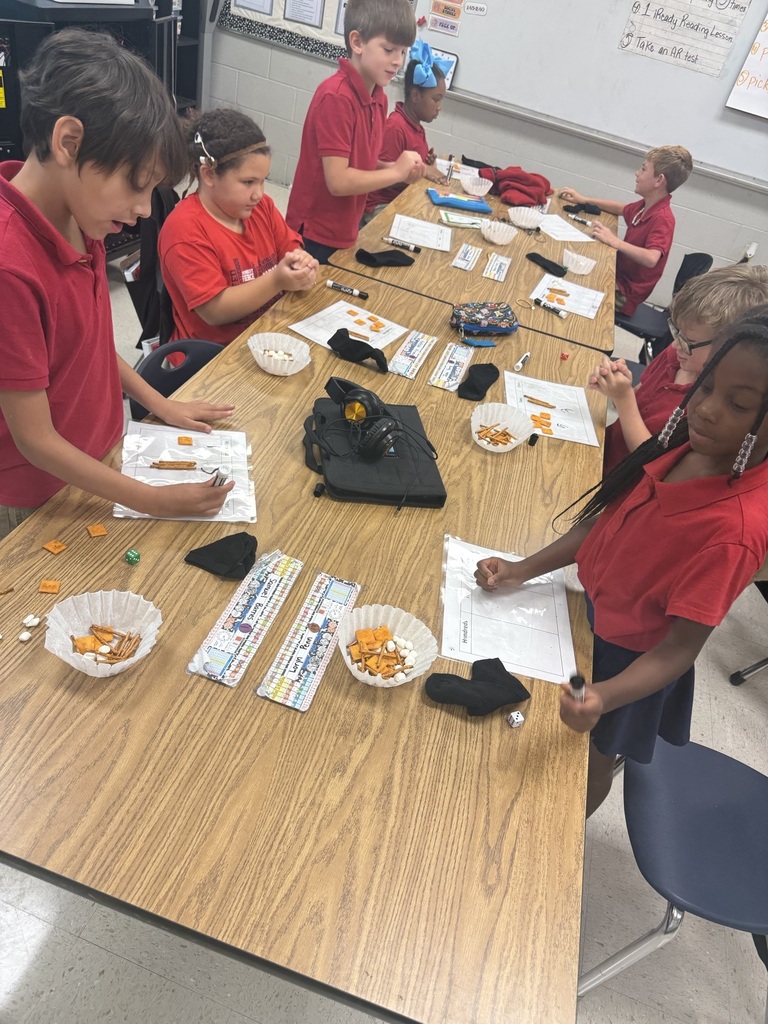 Today we made learning three-digit numbers extra fun! 🔢✨ Ms. Weaver's second graders rolled dice to build a number for each place value on their HTO (Hundreds-Tens-Ones) chart. Then we used Cheez-Its for hundreds, pretzel rods for tens, and marshmallows for ones to build/represent our numbers! 🧀🥨☁️