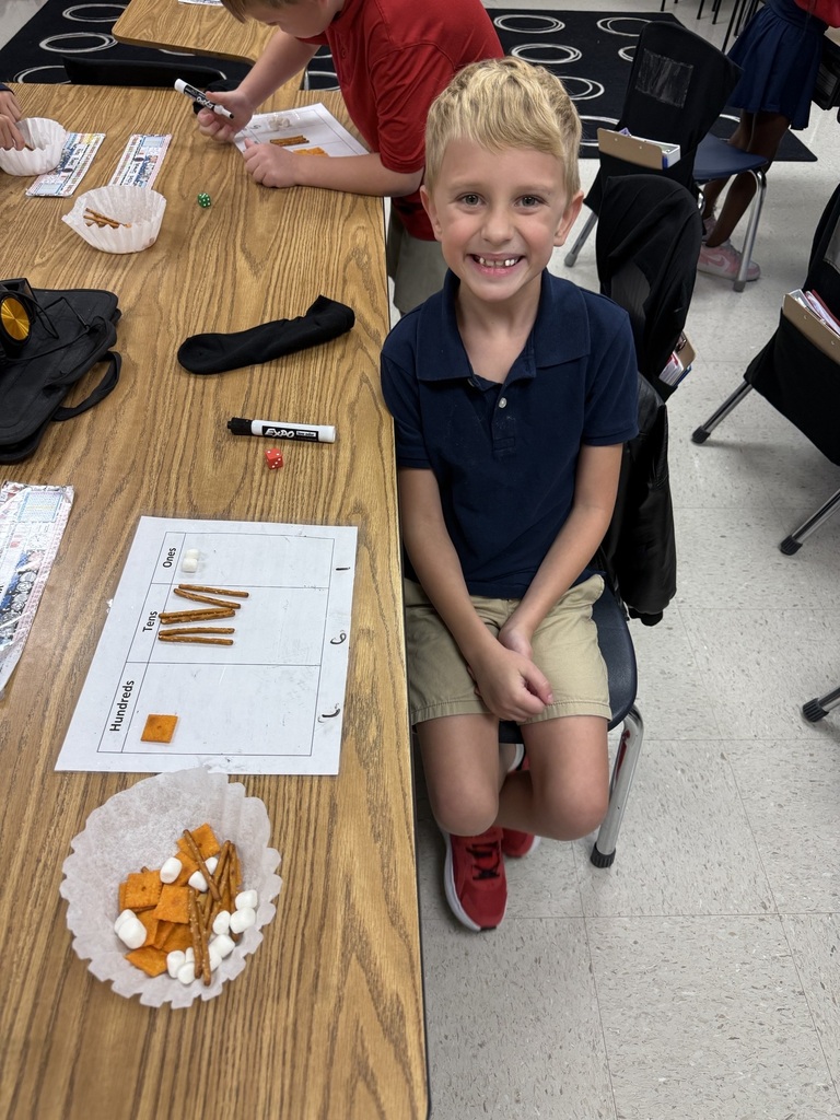 Today we made learning three-digit numbers extra fun! 🔢✨ Ms. Weaver's second graders rolled dice to build a number for each place value on their HTO (Hundreds-Tens-Ones) chart. Then we used Cheez-Its for hundreds, pretzel rods for tens, and marshmallows for ones to build/represent our numbers! 🧀🥨☁️