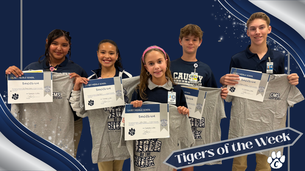 Five children hold up certificates and grey T-shirts, labeled Tigers of the Week, in front of a blue background.