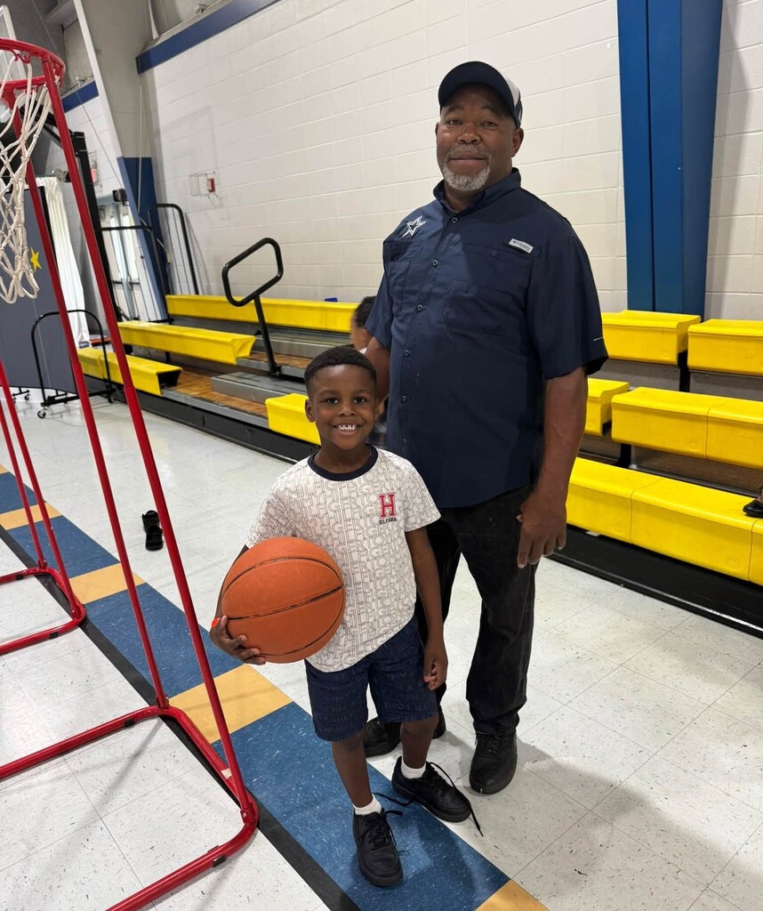 A man with a boy holding a basketball