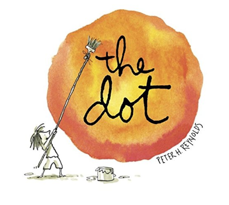 A small child holds a broom and bucket, painting a large orange circle with "the dot" in black ink.