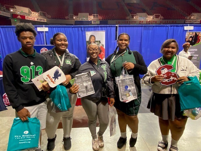 Vigor students holding swag bags from colleges
