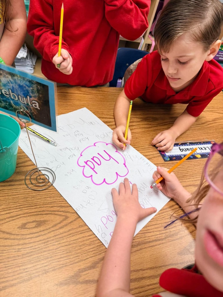 First grade playing freeze and write to review letter sounds and high frequency words: