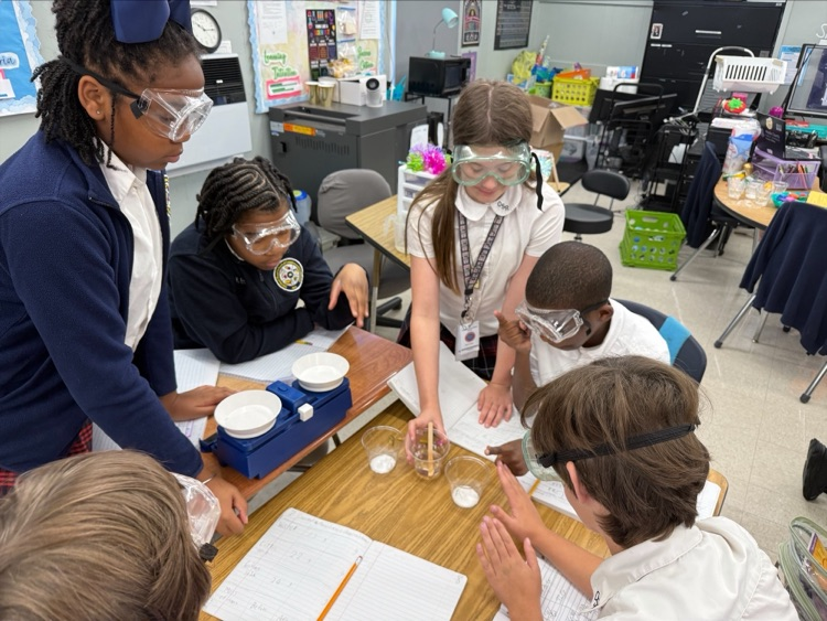 Mrs. Barnes’ fifth-grade students conduct a science experiment by mixing baking soda with a citric acid solution to observe a chemical reaction and learn about the Law of Conservation of Matter.
