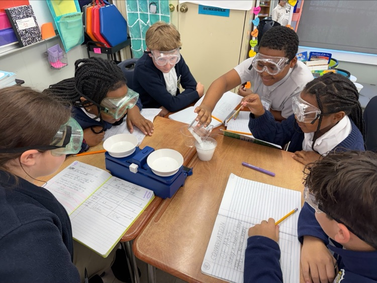 Mrs. Barnes’ fifth-grade students conduct a science experiment by mixing baking soda with a citric acid solution to observe a chemical reaction and learn about the Law of Conservation of Matter.