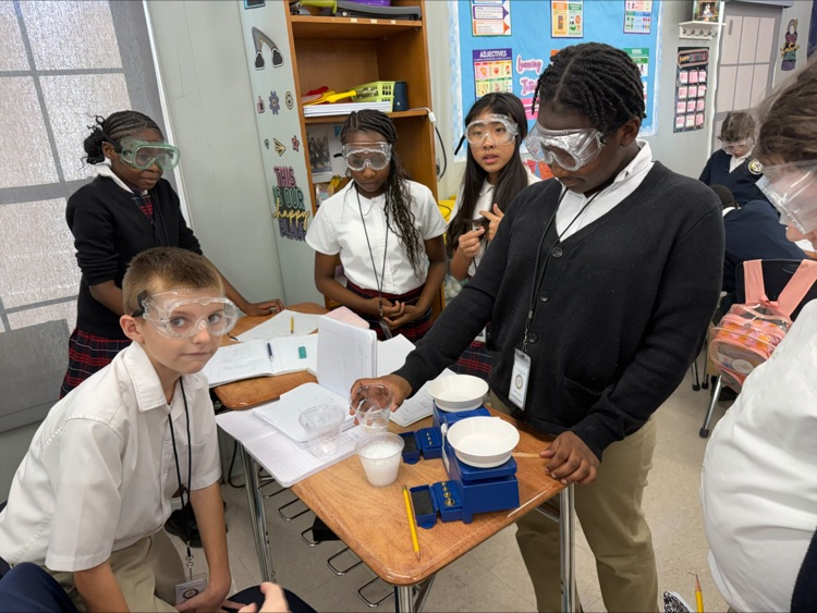 Mrs. Barnes’ fifth-grade students conduct a science experiment by mixing baking soda with a citric acid solution to observe a chemical reaction and learn about the Law of Conservation of Matter.