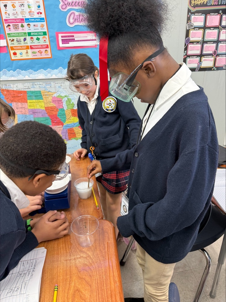 Mrs. Barnes’ fifth-grade students conduct a science experiment by mixing baking soda with a citric acid solution to observe a chemical reaction and learn about the Law of Conservation of Matter.