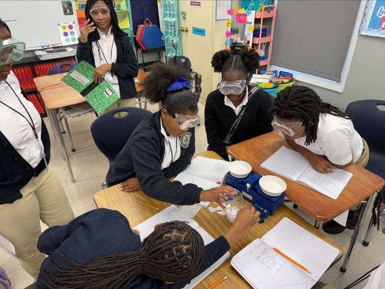 Mrs. Barnes’ fifth-grade students conduct a science experiment by mixing baking soda with a citric acid solution to observe a chemical reaction and learn about the Law of Conservation of Matter.