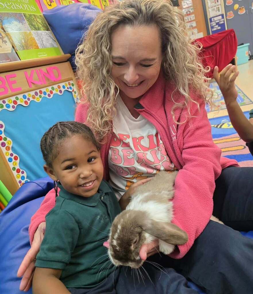 A woman and a girl hold a bunny