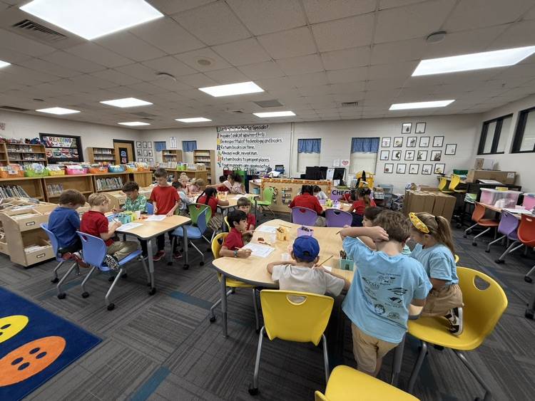 Second grade students creating bar graphs in the library