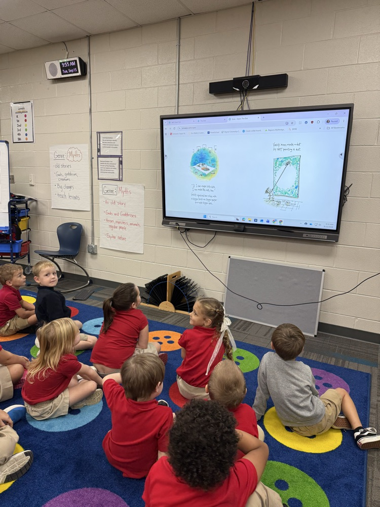 kindergarten listening to the dot read aloud in the library