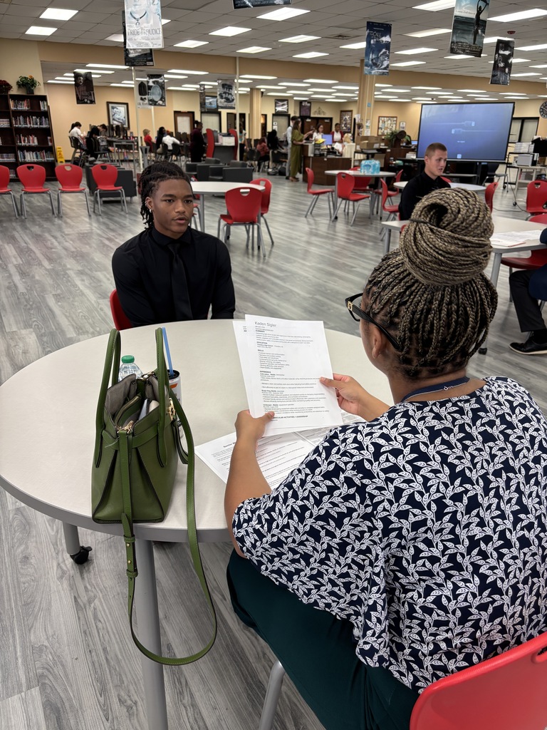 Two students conducting mock interviews at Theodore