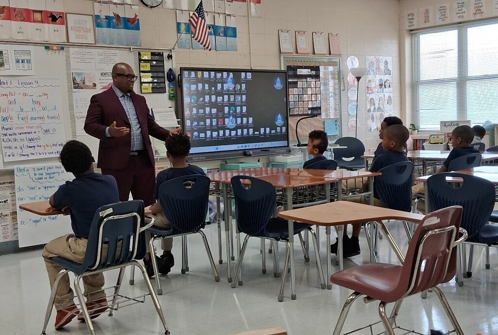 A man talking to students in a classroom