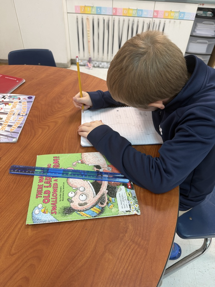 student measuring library book