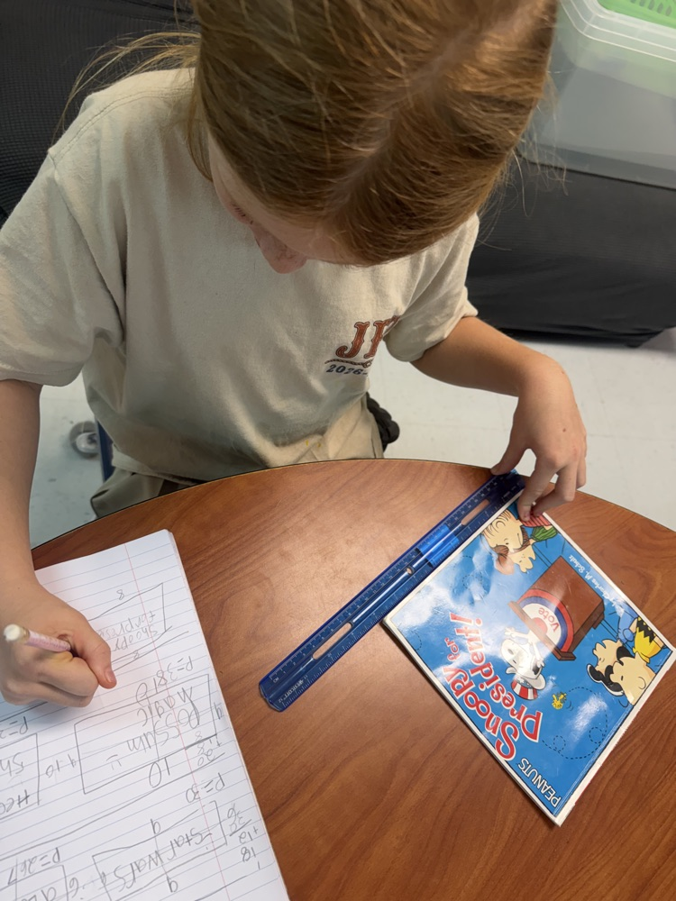 student measuring Library book