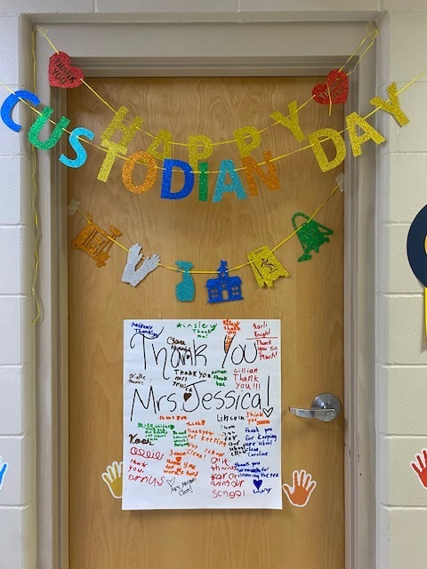 A door with a colorful banner saying "Happy Custodian Day" and a sign with "Thank You Mrs. Jessica" on it.