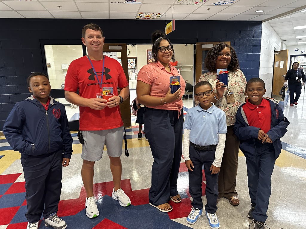 Collins-Rhodes Coaches receiving a gift from the Collins-Rhodes PTO.