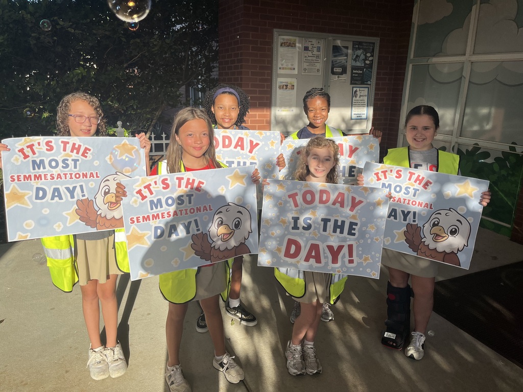 Students holding up signs that read "It's the most Semmesational Day!"