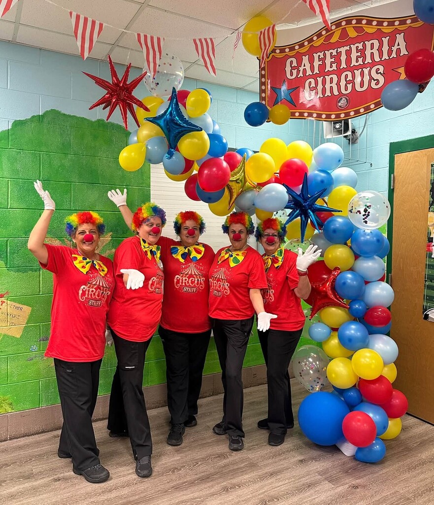 Five cafeteria workers dressed as clowns