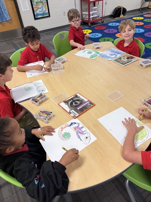 students at a table coloring prediction in the library