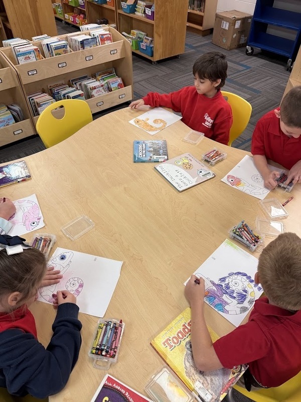 students at a table coloring prediction in the library
