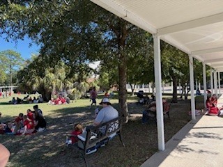 students and parents eating a picnic lunch