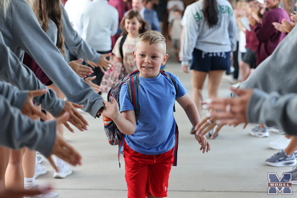 boy getting high-fives