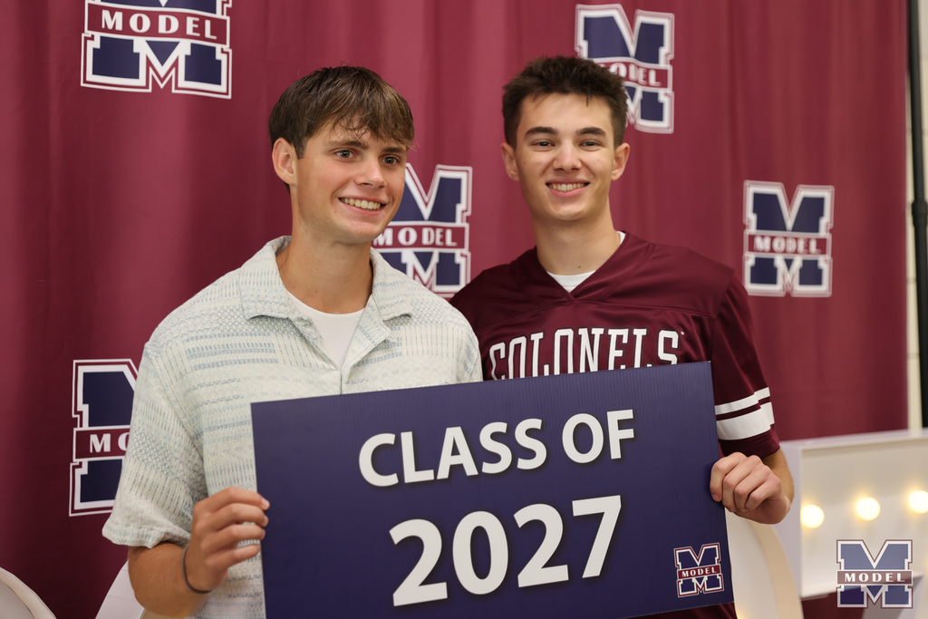 holding class of 2027 sign