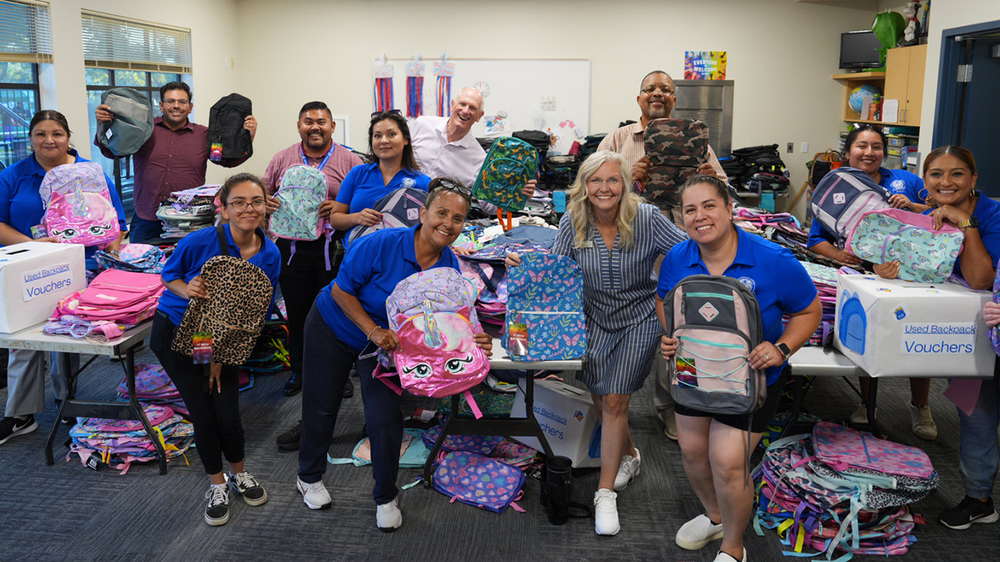 Group of PEO staff and Board trustees at backpack giveaway