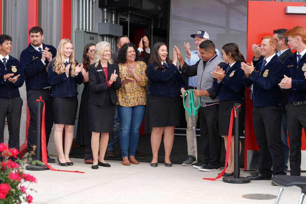 Board of Education and Modesto High FFA students cut the ribbon at Modesto High Ag Farm ribbon-cutting ceremony
