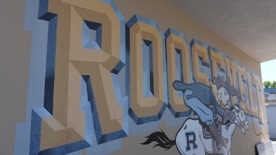 Roosevelt Junior High mural depicting the school name and Rough Rider logo on side of building inside the campus