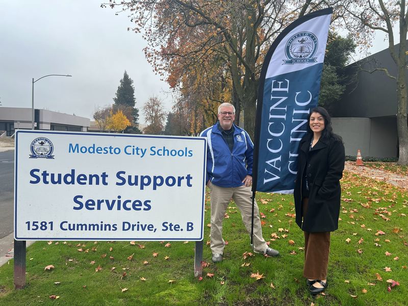 Health Services Director Tom Nipper and Staff Secretary Boutsikakis pose outside the new MCS Vaccine Clinic located inside the Student Support Services building.