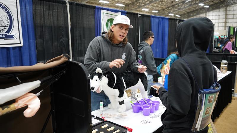 A Animimal Science CTE student shares information about the program with an eighth grader at Inspire Youth, Inspire Dreams Expo.