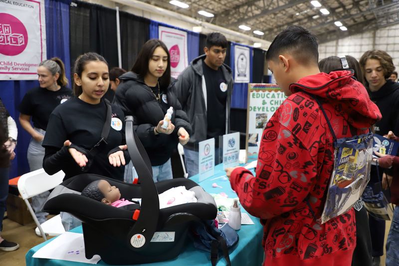 Health Science CTE students discuss program with eighth grade students.