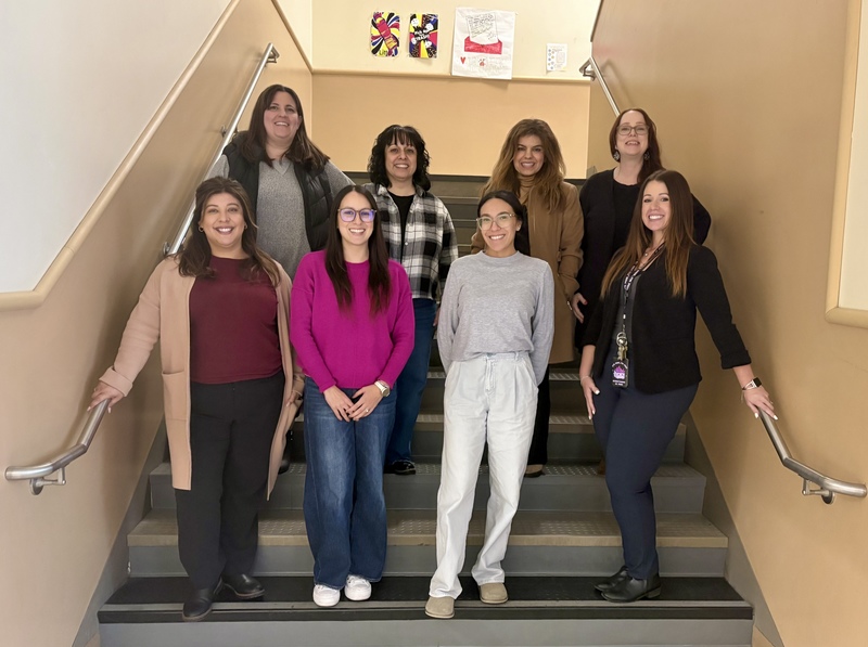 Enochs High School Counseling Team poses for a picture on a staircase on campus. 
