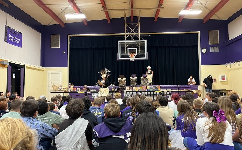 Students watching a cultural assembly.