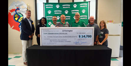 Staff members accepting check