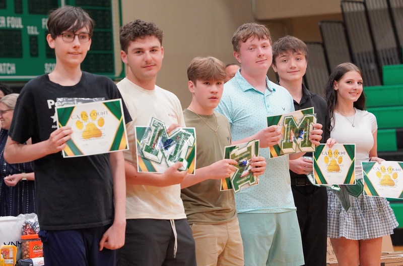 Photos of students holding their awards