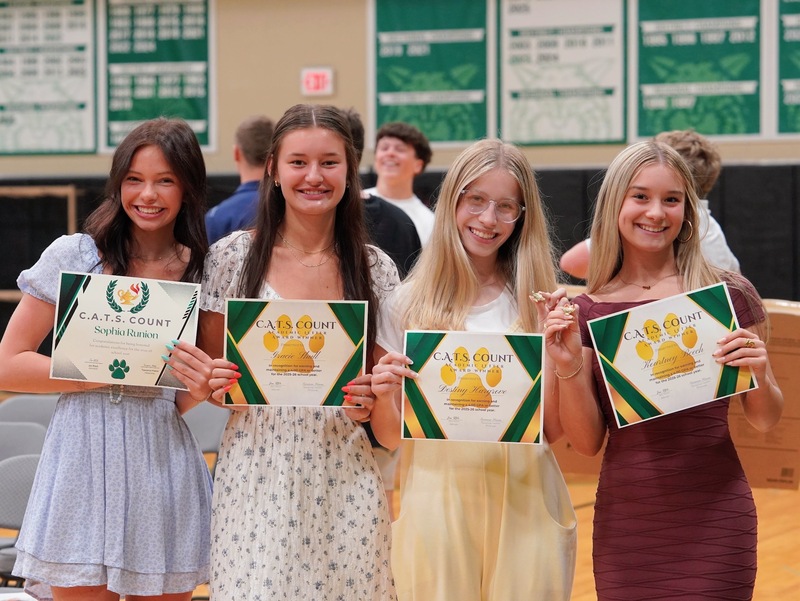 Photos of students holding their awards