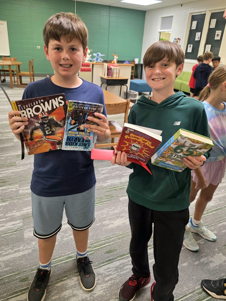 students holding books