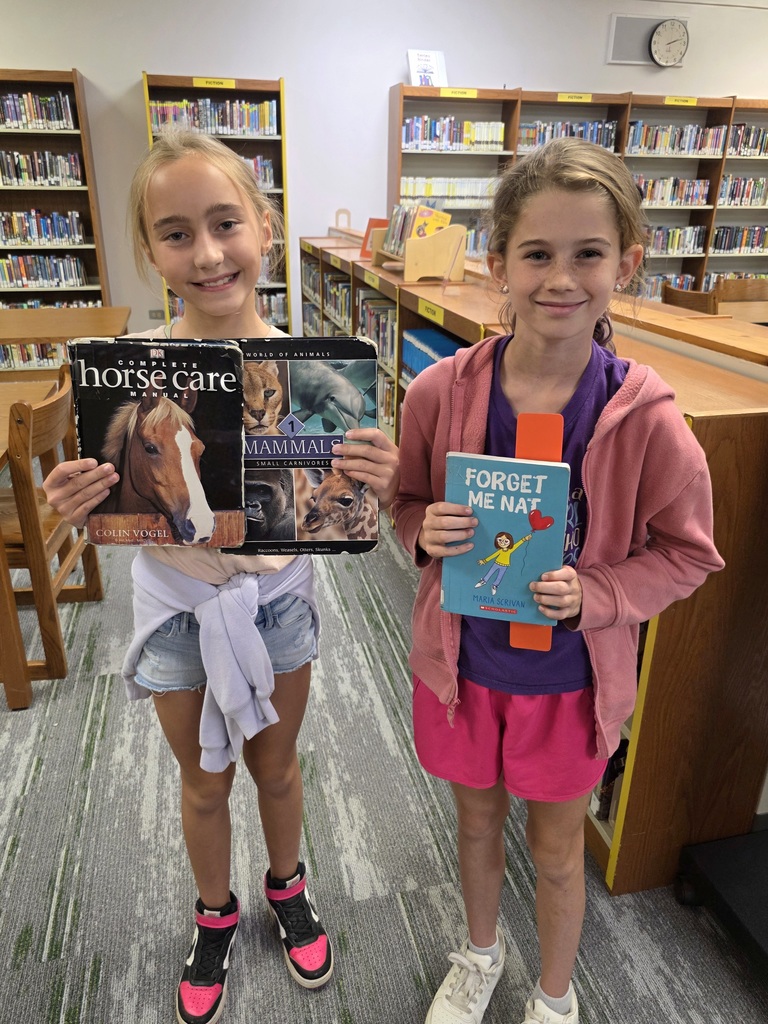 students holding books